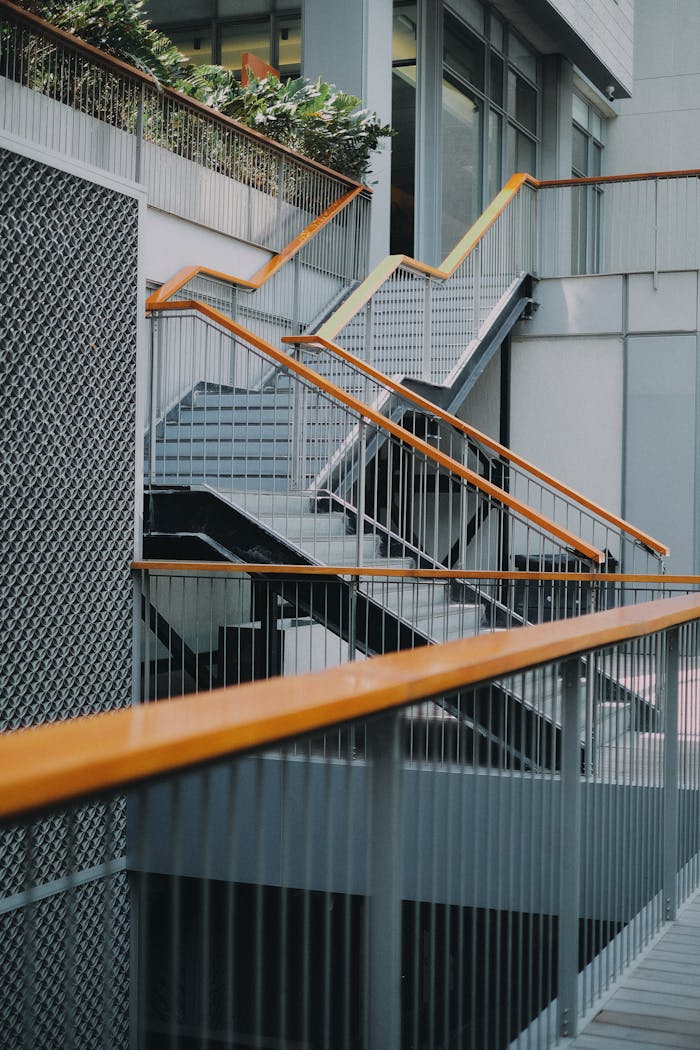 Vertical shot of a modern metal staircase with handrails in a building in Dubai, UAE.