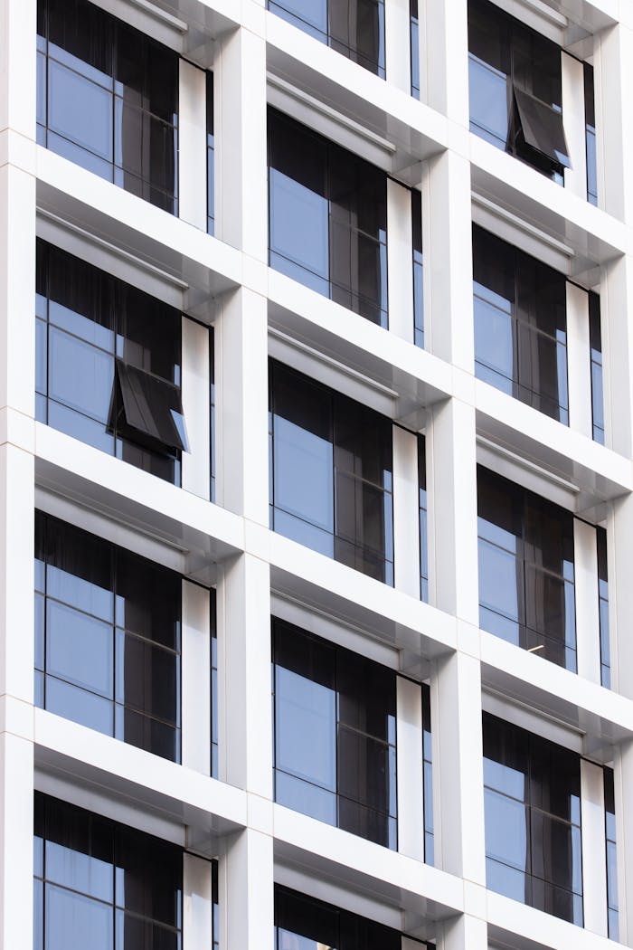 Close-up of a modern building facade featuring geometric windows with a sleek and minimal design.